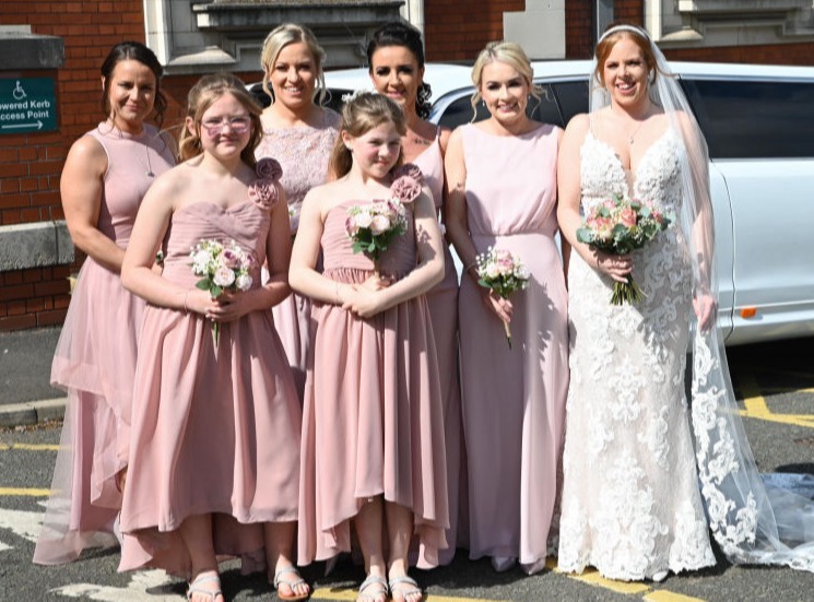 The bridesmaids and bride gather for the last picture be fore heading into the Stockport town hall marble staircase  wedding 
